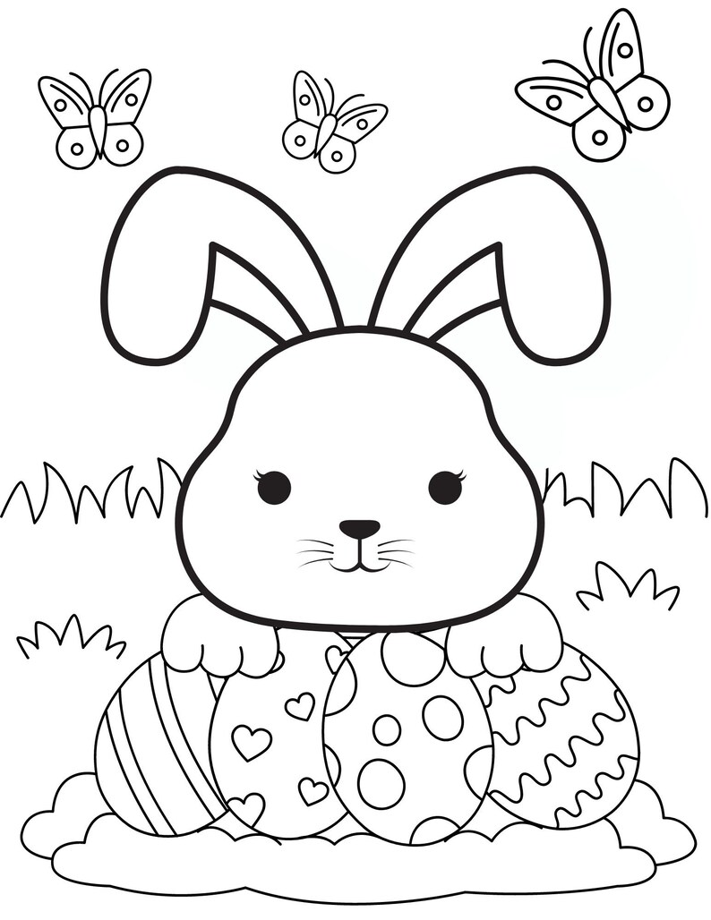 May include: A black and white line drawing of a bunny rabbit holding three Easter eggs. The bunny has large ears and a cute face. The eggs are decorated with stripes, hearts, and polka dots. There are two butterflies above the bunny.