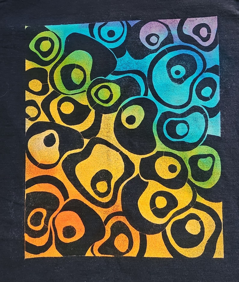 May include: Abstract art print featuring a pattern of black, organic shapes with colorful gradients. The colors transition from orange to yellow, green, blue, and purple. The artwork is set against a black background.
