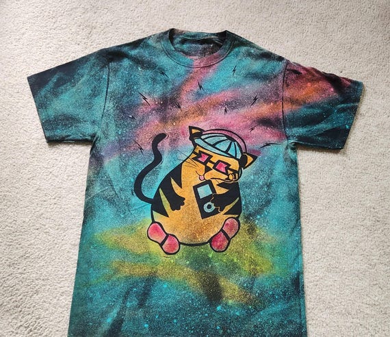 Cute cat with ipod, shoes and baseball cap, bopping to the beat, man's medium discharge t-shirt with procion dyes, pinks, orange and blues