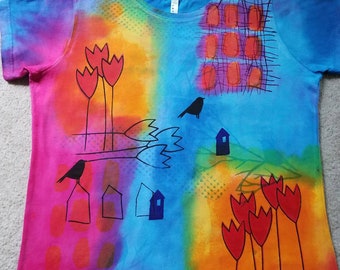 Collage style design, red tulips, birds on branches, small houses, splashes of color, woman's XL dyed & printed t-shirt