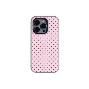 May include: A pink phone case with a repeating pattern of small, evenly spaced brown polka dots. The case has a camera cutout and is designed to fit a smartphone.