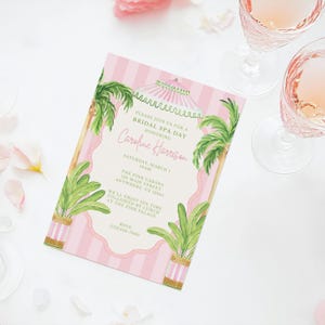 May include: A pink and white striped invitation for a bridal spa day. The invitation features palm trees, a decorative border, and the text "Caroline Harrison" in cursive. The invitation also includes the date, time, and location of the event.
