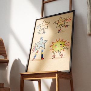 May include: A framed print featuring four whimsical star illustrations. Each star has a smiling face and is depicted with arms and legs, some with ribbons and bows. The artwork is set against a tan background.