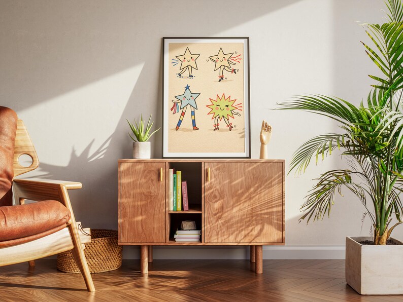 May include: A framed art print featuring four cartoon stars with smiling faces and limbs. The stars are in various poses, with one on roller skates and another with colorful streamers. The artwork is displayed on a wooden cabinet with books and a plant.