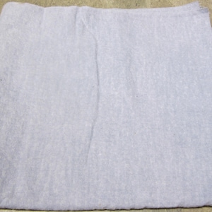 May include: A light blue, rectangular fabric item, possibly a cloth or towel, with a slightly textured surface. The item is folded and appears to be made of a soft material. A loop is visible on one corner.