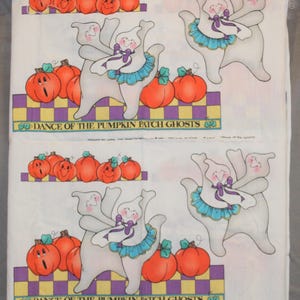 May include: White fabric with a repeating pattern of dancing ghosts and pumpkins. The ghosts are white with purple bows and blue skirts. The pumpkins are orange with green stems and leaves. The text "Dance of the Pumpkin Patch Ghosts" is printed in purple at the bottom of the fabric.