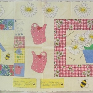 May include: A rectangular fabric panel featuring a cream background with a garden theme. The print includes a yellow birdhouse, pink polka-dot watering cans, a blue pot of white daisies, bees, and red gingham borders. The design is repeated.