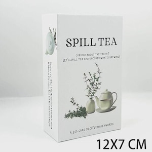 May include: A white card deck titled "SPILL TEA" with text: "Curious about the truth? Let's spill tea and uncover what's brewing!" and "A 80-card deck with keywords." The box measures 12x7 cm.