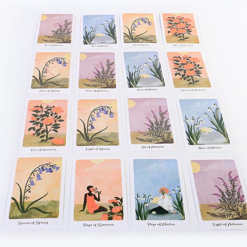 May include: A collection of tarot cards featuring botanical illustrations and figures. Each card displays a unique floral design with titles such as "Five of Summer" and "Eight of Spring." The cards have a soft color palette with pastel backgrounds and sun illustrations.