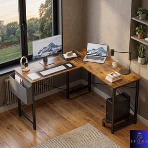 May include: An L-shaped wooden desk with a black metal frame. The desk has a monitor, laptop, keyboard, mouse, and a desk lamp. A computer tower sits on a lower shelf. A window and a bookshelf are in the background.