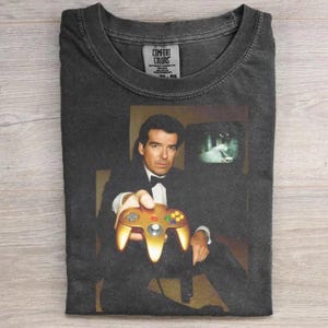 May include: A white ceramic mug with a black handle and the text "But First, Coffee" in a handwritten style. The mug is on a white surface. The mug is likely for hot beverages.