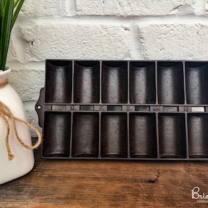 May include: A set of three ceramic mugs with a speckled, matte finish. The mugs are in shades of cream, light gray, and dark gray. Each mug has a simple, minimalist design and a rounded handle.