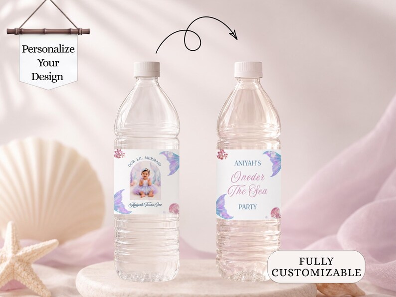 May include: Two clear plastic water bottles with custom labels featuring a mermaid theme. The labels display the text Our Lil Mermaid, Aniyah's Oneder The Sea Party, and a photograph of a child. The design includes purple mermaid tails.