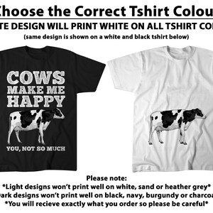 May include: Two t-shirts, one black and one white, each featuring a cow illustration. The black t-shirt has the text "COWS MAKE ME HAPPY, YOU, NOT SO MUCH." The text at the top says "Choose the Correct Tshirt Colour".