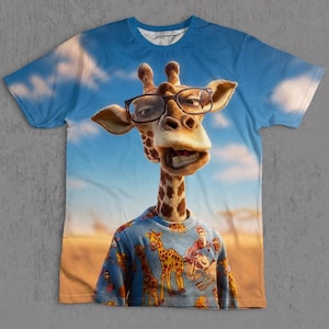 May include: A short-sleeved crew neck t-shirt featuring a large, detailed graphic of a giraffe wearing dark-rimmed glasses. The giraffe is also wearing a blue shirt patterned with smaller giraffe illustrations against a blue sky and savanna background.