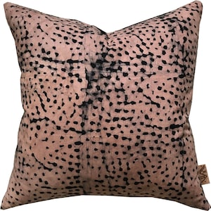 May include: A pink and black patterned throw pillow with a subtle batik design. The pillow is made of a soft, comfortable fabric and features a unique, abstract pattern.