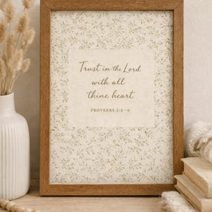 Puede incluir: Una impresi&oacute;n enmarcada con el texto "Trust in the Lord with all thine heart" y "PROVERBIOS 3:5-6". La impresi&oacute;n tiene un patr&oacute;n floral y est&aacute; en un marco de madera marr&oacute;n. La imagen est&aacute; sobre una superficie de madera.
