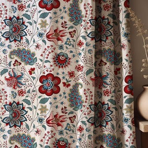 May include: A curtain featuring a repeating floral and paisley pattern in shades of red, blue, and muted green on a cream-colored fabric background. The design includes stylized blossoms, delicate vines, and intricate leaf motifs throughout.