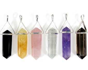 May include: Six crystal point pendants with silver settings. The crystals are black, yellow, pink, clear, purple, and brown.