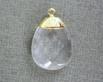May include: A clear teardrop-shaped crystal pendant with a gold-toned cap and a loop for hanging.