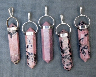 May include: Five silver and pink gemstone pendants with a pointed tip. The pendants are made of a pink and black stone with a silver bail.