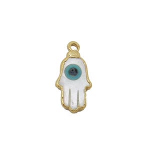 May include: Gold charm with a white hamsa hand with a blue evil eye in the center.