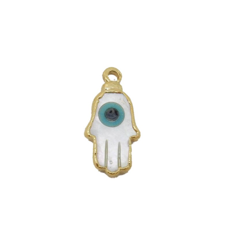 May include: Gold charm with a white hamsa hand with a blue evil eye in the center.