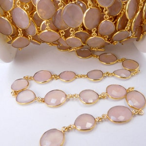 May include: A collection of Rose Pink Chalcedony Gold Plated Bezel Station Connector Chain Per Foot on white surface for reference.