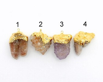 May include: Four gold-plated crystal pendants with different shapes and colors. The crystals are a mix of clear, pink, and purple.