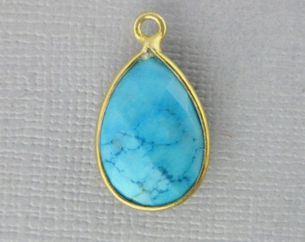 May include: A gold-tone pendant with a turquoise gemstone in a teardrop shape.