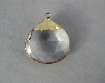 May include: A clear glass teardrop pendant with a gold-plated top and a loop for hanging.