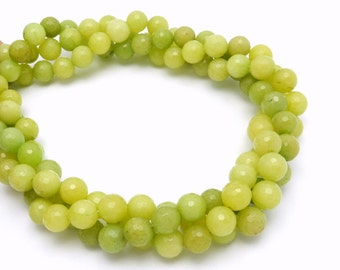 May include: A strand of light green jade beads. The beads are round and have a smooth, polished finish.