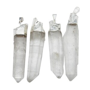 May include: Four clear quartz crystal pendants with silver caps. The crystals are all different shapes and sizes.
