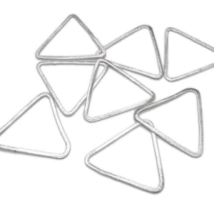 May include: A collection of silver-colored, triangular metal jewelry findings. The triangles have a textured surface and are arranged in a scattered pattern against a white background. These findings are suitable for jewelry making and crafting projects.
