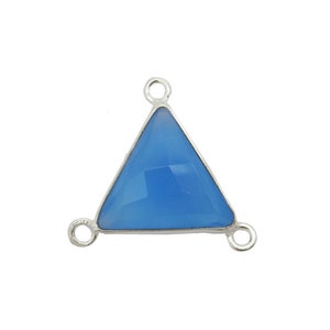 May include: A silver triangle pendant with a light blue chalcedony gemstone. The pendant has three jump rings for attaching to a chain or cord.