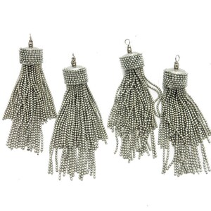 May include: Four silver tassel pendants with a round bead at the top. The tassels are made of small silver beads.
