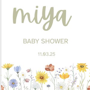 May include: A baby shower sign with the name "miya" in a soft green script. The words "welcome to" and "baby shower" are also included. The bottom of the sign features a watercolor floral border with yellow, blue, and orange flowers.