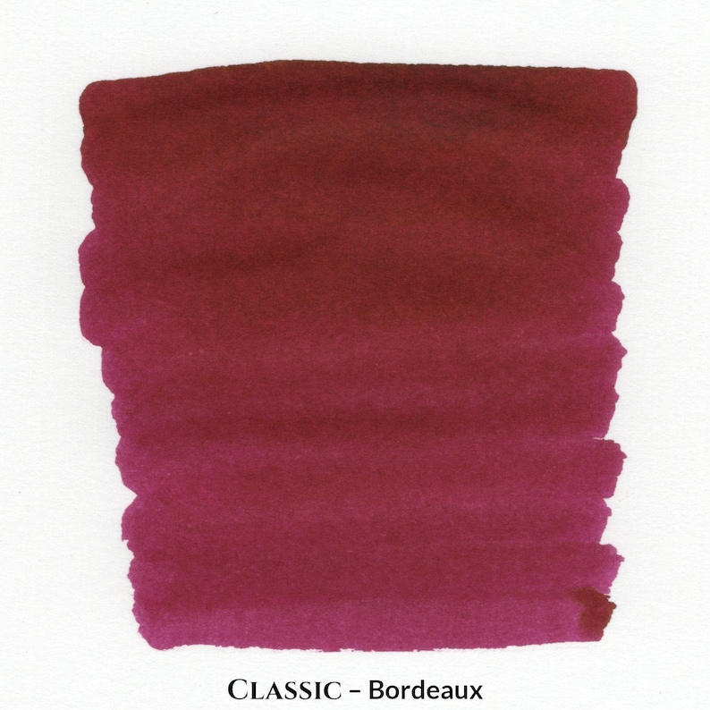 May include: A rectangular swatch of deep burgundy ink, with a gradient from dark at the top to a lighter shade at the bottom. The text "CLASSIC - Bordeaux" is printed at the bottom of the swatch.
