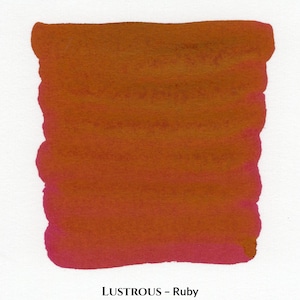 May include: A rectangular ink swatch in shades of orange and red, with the text "LUSTROUS - Ruby" at the bottom. The colour transitions from a deep red at the bottom to a lighter orange at the top, with visible brush strokes.