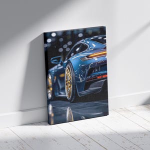May include: A canvas print featuring a blue sports car with gold-colored rims. The car's rear is visible, showcasing its taillights and sleek design. The image is set against a dark background, with reflections on the surface.