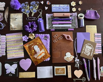 May include: A collection of stationery and accessories in shades of purple, including a brown notebook, pens, a purple coin purse, stickers, bookmarks, sticky notes, a clear pencil case, a small purple scrunchie, and various decorative paper clips.