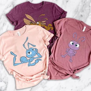 May include: A white ceramic mug with a black handle and the text "But First, Coffee" in a black, handwritten-style font. The mug is on a white surface.