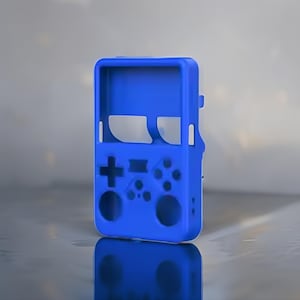 May include: A vibrant blue silicone protective case for a handheld gaming device. The case features a D-pad, buttons, and a screen cutout, mirroring the design of a classic retro console. The case is designed to protect the device from scratches and impacts.