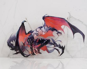 May include: A clear acrylic standee featuring a crouching, winged humanoid figure with white hair, dark armor-like markings, and large, vibrant red and black wings. The character is depicted in a dynamic pose with sharp claws and metallic chains.