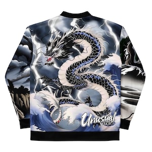 May include: A black bomber jacket featuring a detailed illustration of a dragon amidst stormy clouds and crashing waves. The dragon is primarily black and white with blue accents. The text "Unusual Style" is visible on the lower right.