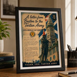 May include: A framed poster titled A letter from Boston to the Tartan Army FIFA WORLD CUP 2026 featuring a statue wearing an orange traffic cone, the Custom House Tower, a Scottish flag, and text expressing gratitude to the Tartan Army.