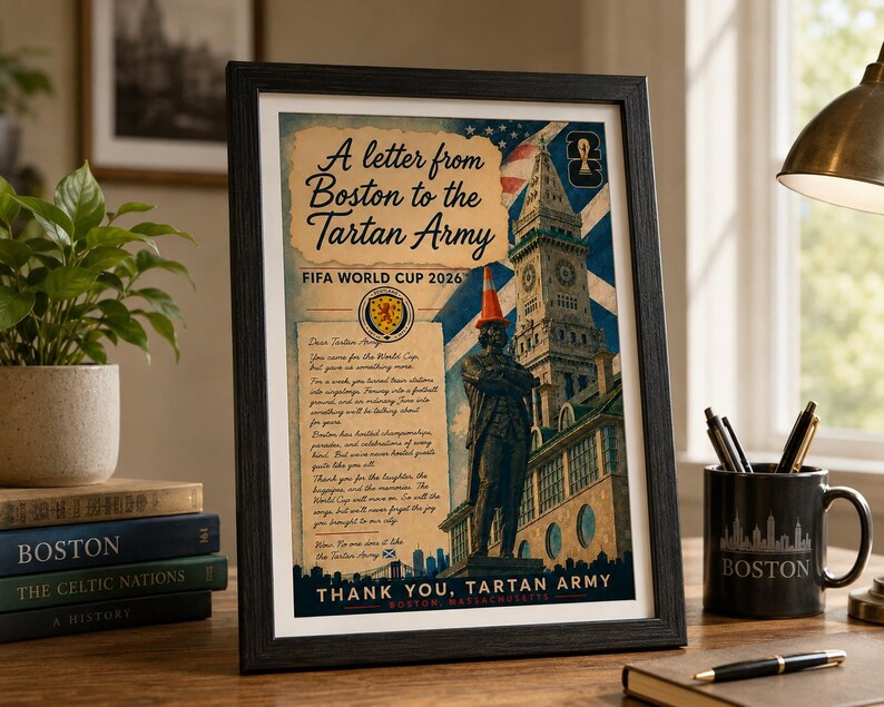 May include: A framed poster titled A letter from Boston to the Tartan Army FIFA WORLD CUP 2026 featuring a statue wearing an orange traffic cone, the Custom House Tower, a Scottish flag, and text expressing gratitude to the Tartan Army.