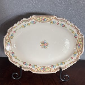 Mount Clemens Pottery oval serving platter in the "Mildred" pattern featuring a center floral motif.