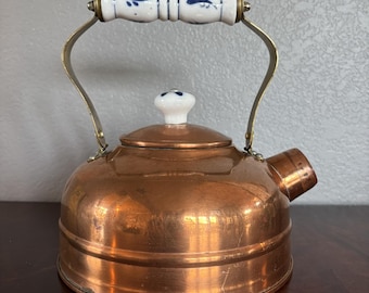 Vintage solid copper tea kettle featuring Delft-style blue and white porcelain details