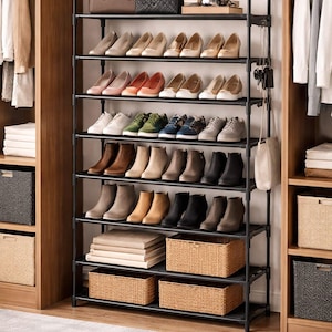 May include: A black metal shoe rack filled with various shoes, boots, and accessories. The rack has multiple shelves holding heels, flats, and boots in various colors. There are also baskets and a hat on top.